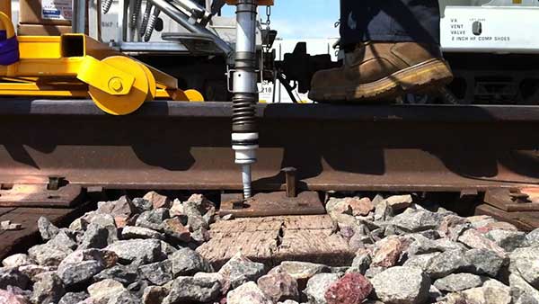 push rail spike in the hole of rail tie plate